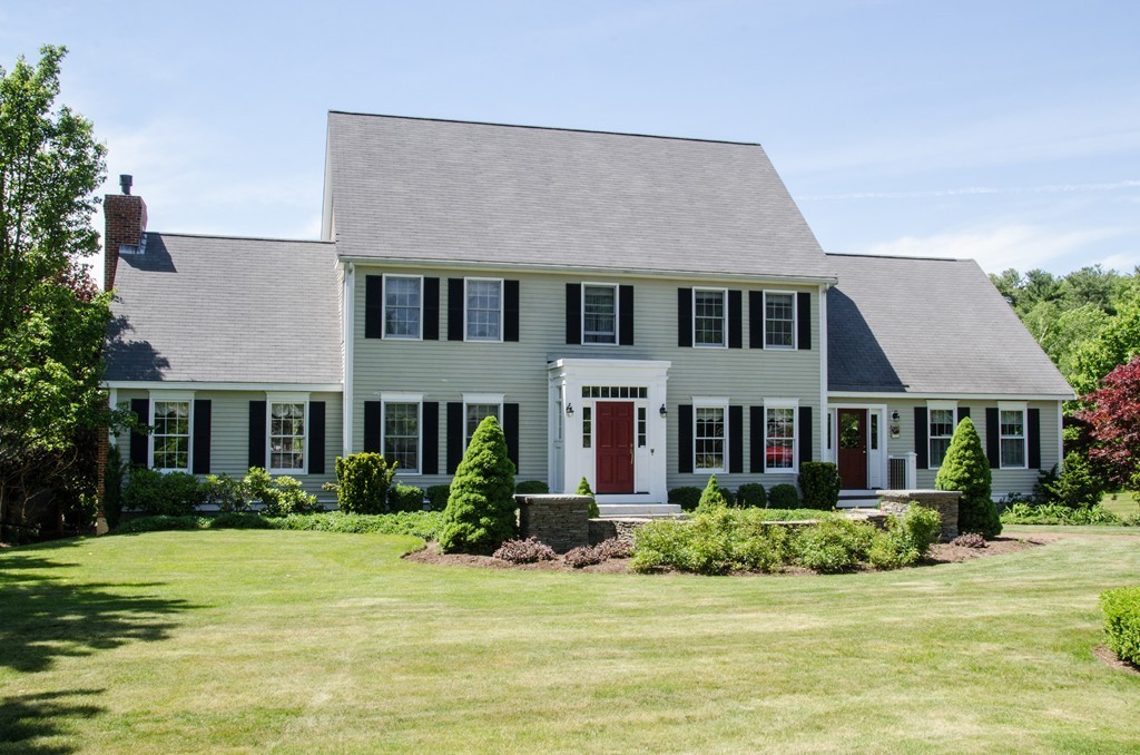 690 Bay Road Hamilton, MA 01982 - Photo 2 of 26 a front view of a house with a yard and garage