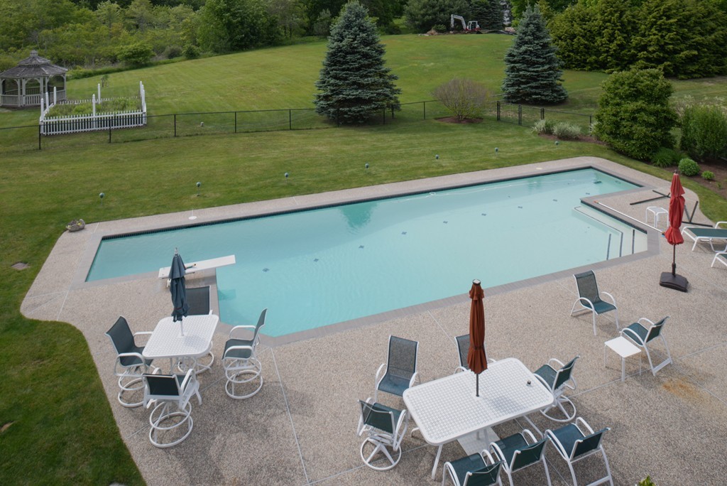 690 Bay Road Hamilton, MA 01982 - Photo 3 of 26 a view of a patio with table and chairs with swimming pool