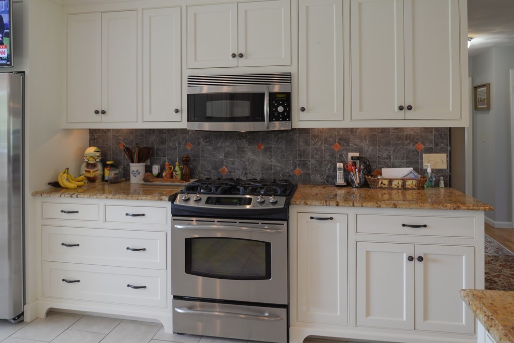690 Bay Road Hamilton, MA 01982 - Photo 7 of 26 a kitchen with white cabinets and appliances