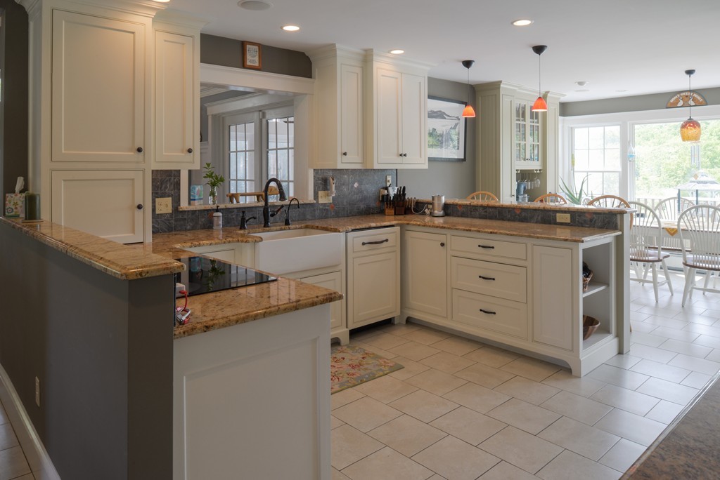 690 Bay Road Hamilton, MA 01982 - Photo 8 of 26 a kitchen with kitchen island granite countertop a sink counter top space and cabinets