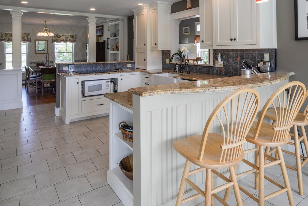 690 Bay Road Hamilton, MA 01982 - Photo 9 of 26 a kitchen with stainless steel appliances granite countertop a sink and a refrigerator