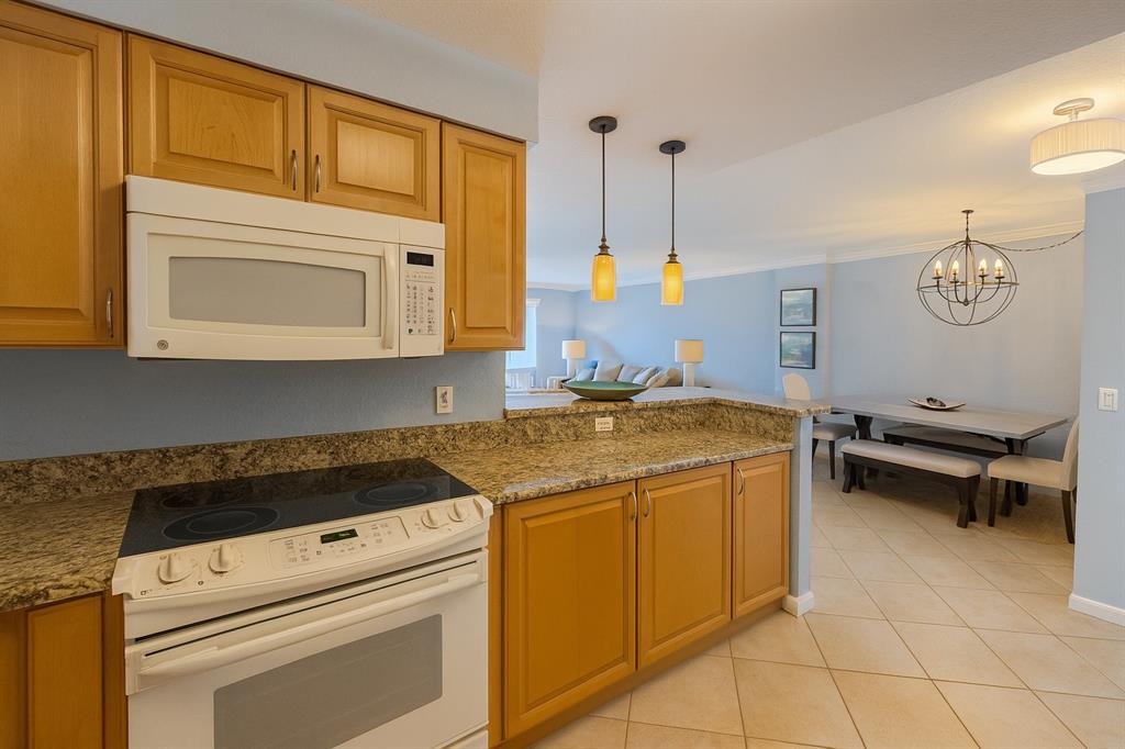 1000 Spanish River Road, Unit 3G Boca Raton, FL 33432 - Photo 17 of 31 a kitchen with a stove and a microwave
