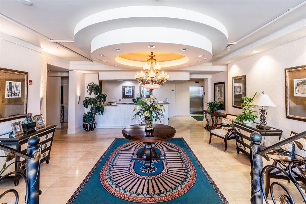 1000 Spanish River Road, Unit 3G Boca Raton, FL 33432 - Photo 4 of 31 a living room with furniture a chandelier and a flat screen tv