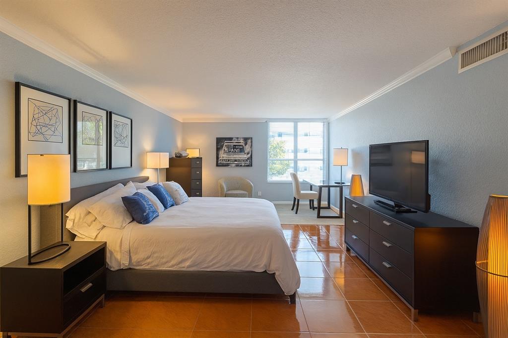 1000 Spanish River Road, Unit 3G Boca Raton, FL 33432 - Photo 5 of 31 a bedroom with a bed and flat tv