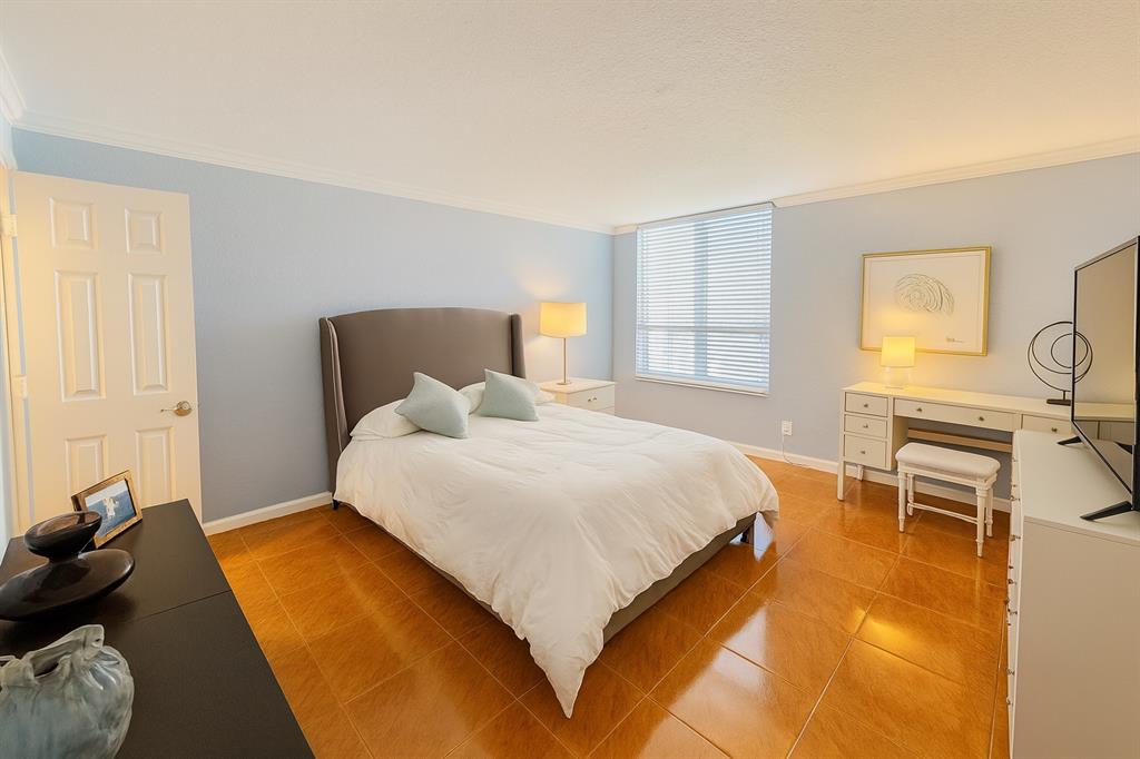 1000 Spanish River Road, Unit 3G Boca Raton, FL 33432 - Photo 10 of 31 a bedroom with a bed and wooden floor