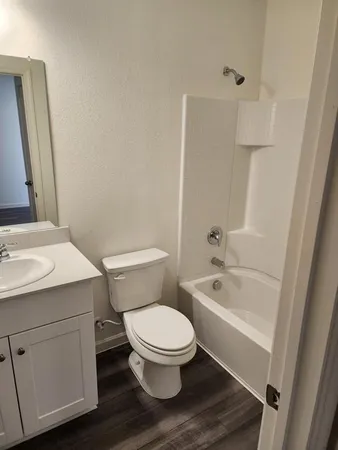 a bathroom with a toilet a sink and bathtub