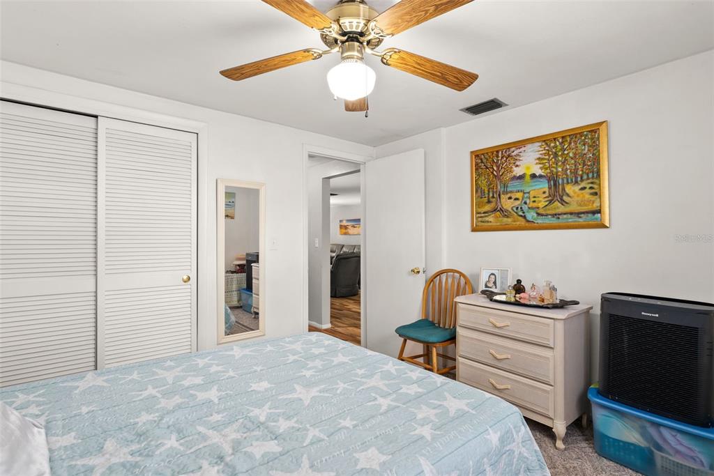 4227 Rax Place, Unit 4227 New Port Richey, FL 34652 - Photo 14 of 42 a bedroom with a bed and a chandelier