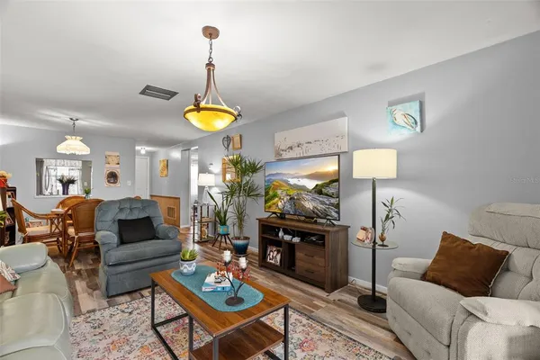 a living room with furniture a chandelier and a chandelier