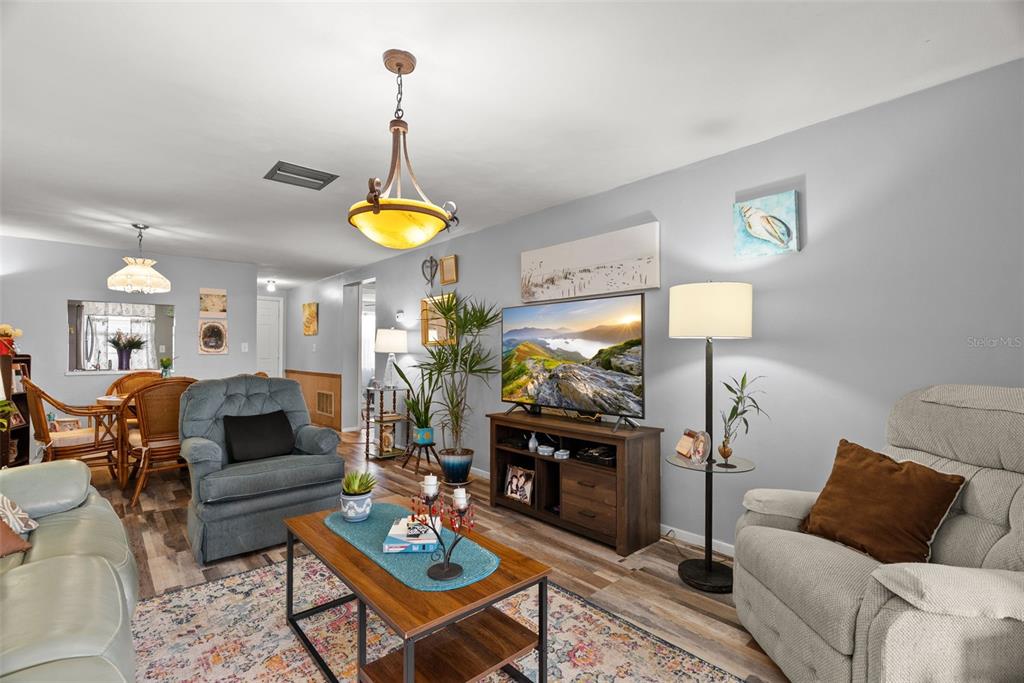 4227 Rax Place, Unit 4227 New Port Richey, FL 34652 - Photo 18 of 42 a living room with furniture a lamp and a table