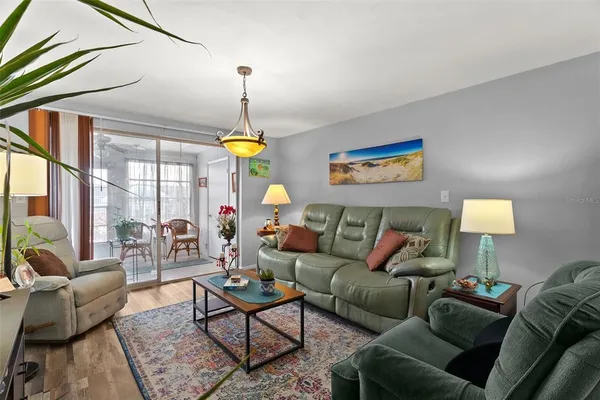a living room filled with furniture and a ceiling fan