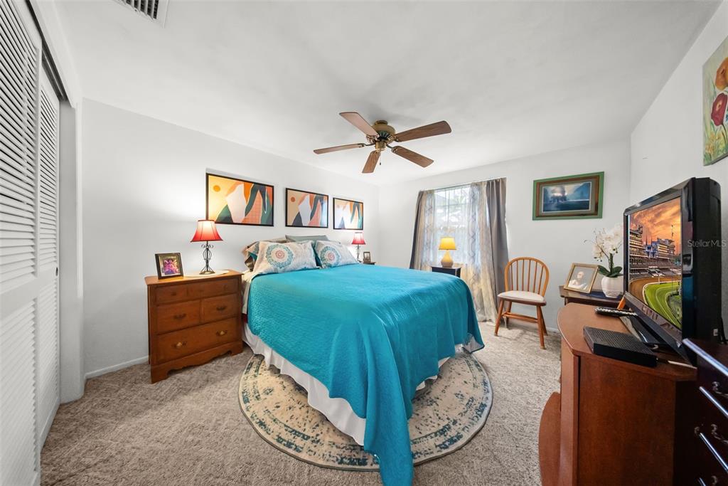 4227 Rax Place, Unit 4227 New Port Richey, FL 34652 - Photo 3 of 42 a bedroom with furniture and a flat screen tv