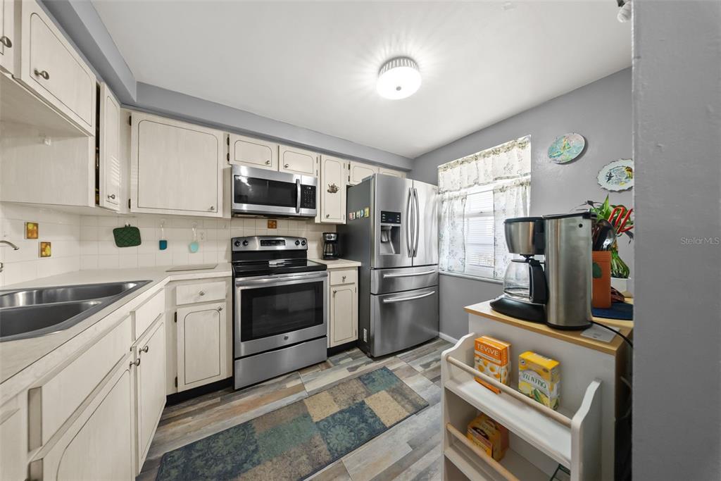 4227 Rax Place, Unit 4227 New Port Richey, FL 34652 - Photo 7 of 42 a kitchen with a stove a sink and a microwave