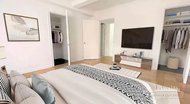 a bedroom with a bed and a flat screen tv