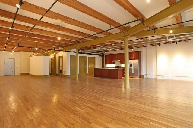 a view of a empty room with wooden floor