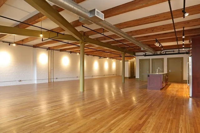 a view of a room with wooden floors