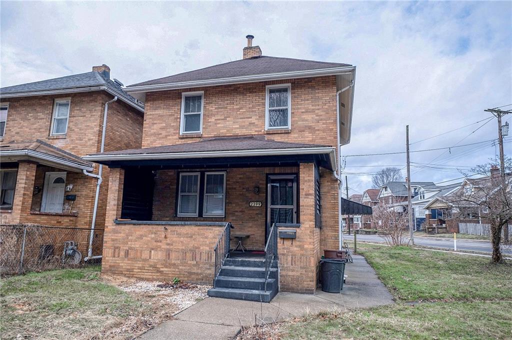 a front view of a house with a yard
