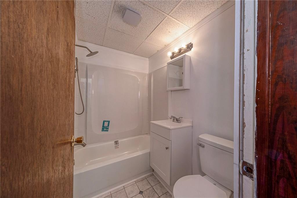 2399 Beaver Road Ambridge, PA 15003 - Photo 15 of 24 a bathroom with a toilet and a bathtub
