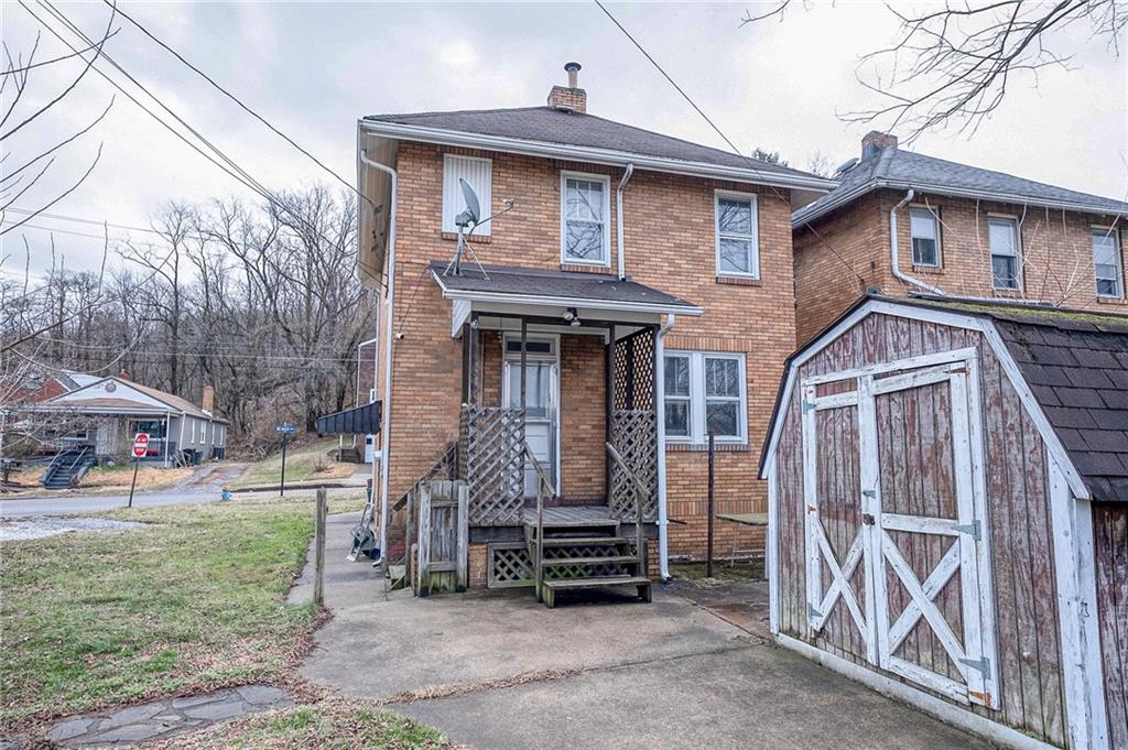2399 Beaver Road Ambridge, PA 15003 - Photo 23 of 24 a front view of a house with garden