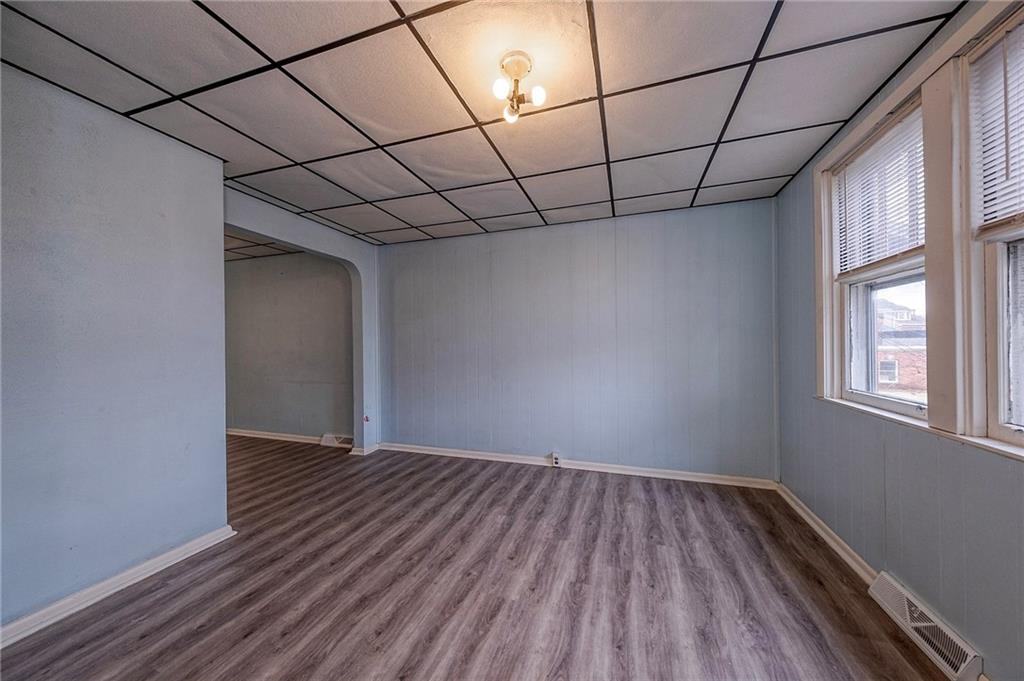 2399 Beaver Road Ambridge, PA 15003 - Photo 7 of 24 a view of a room with wooden floor and a window