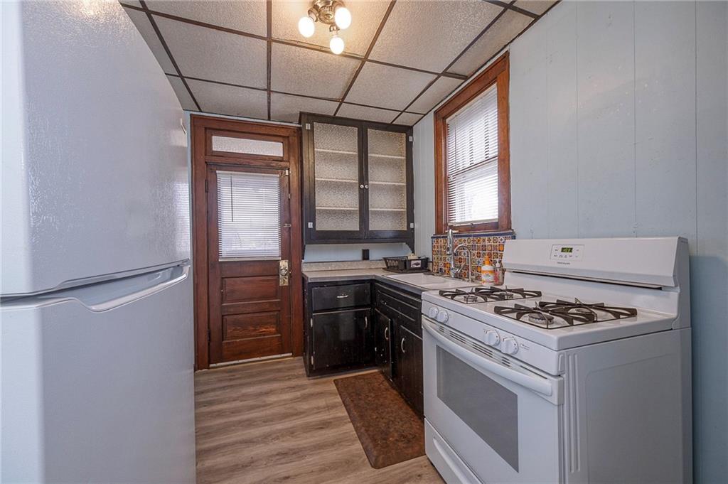 2399 Beaver Road Ambridge, PA 15003 - Photo 8 of 24 a kitchen with stainless steel appliances granite countertop a stove cabinets and refrigerator