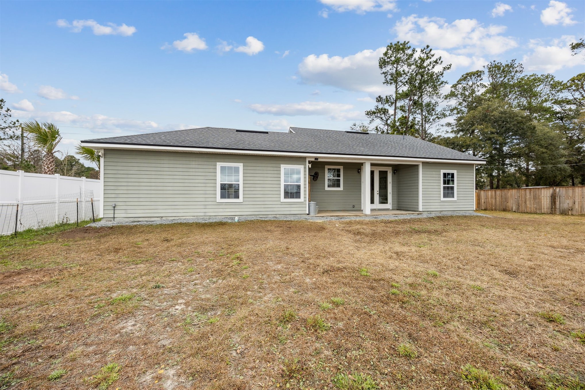96718 Blackrock Road Yulee, FL 32097 - Photo 51 of 54 a backyard of a house with large trees