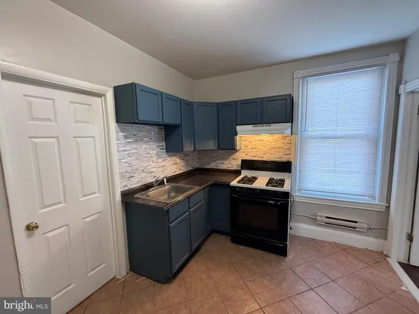 a kitchen with stainless steel appliances granite countertop a stove and a refrigerator