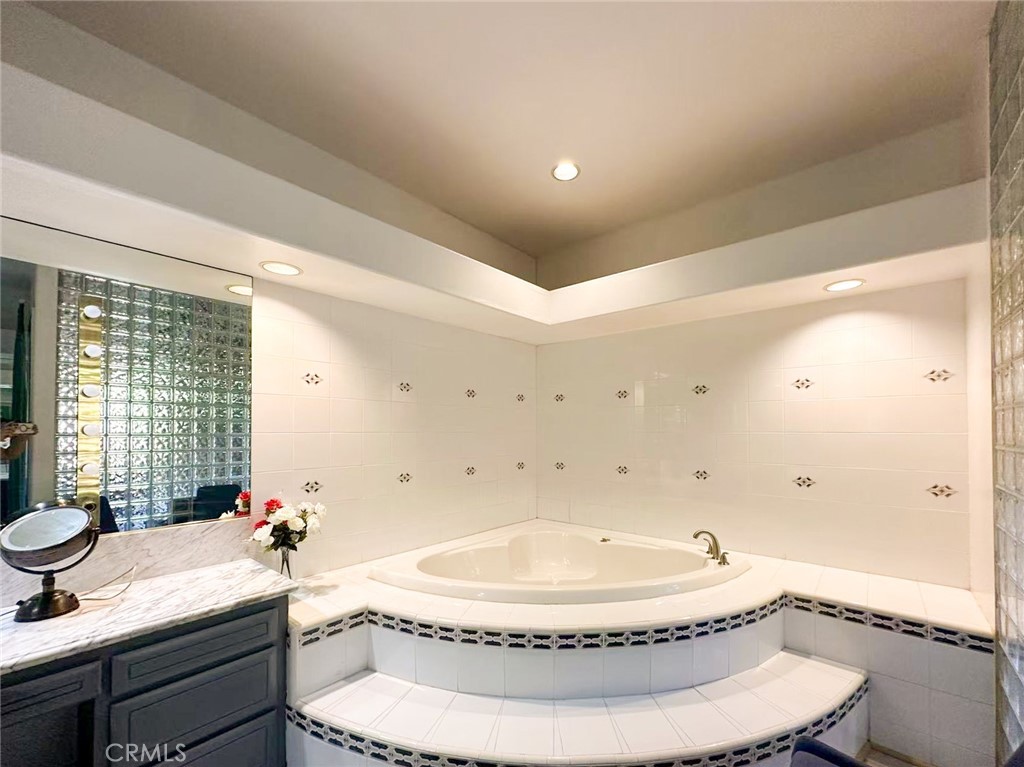 45700 Adler Lane Temecula, CA 92590 - Photo 13 of 20 a bathroom with a granite countertop sink a toilet and shower