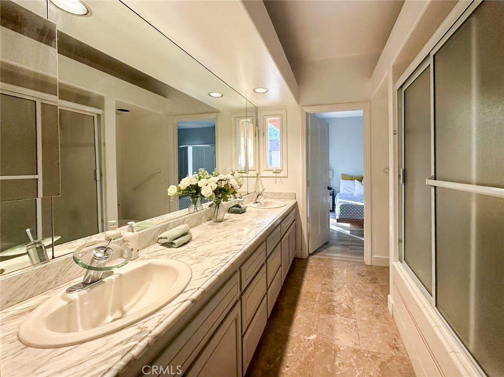 45700 Adler Lane Temecula, CA 92590 - Photo 14 of 20 a en suite bathroom with a double vanity sink and mirror