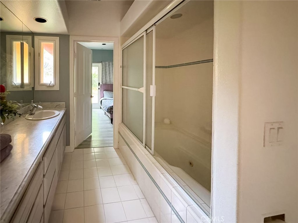 45700 Adler Lane Temecula, CA 92590 - Photo 15 of 20 a bathroom with a mirror and a shower