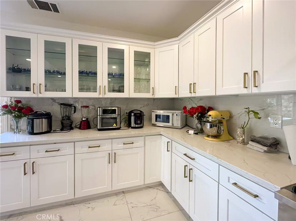 45700 Adler Lane Temecula, CA 92590 - Photo 8 of 20 a kitchen with white cabinets and window