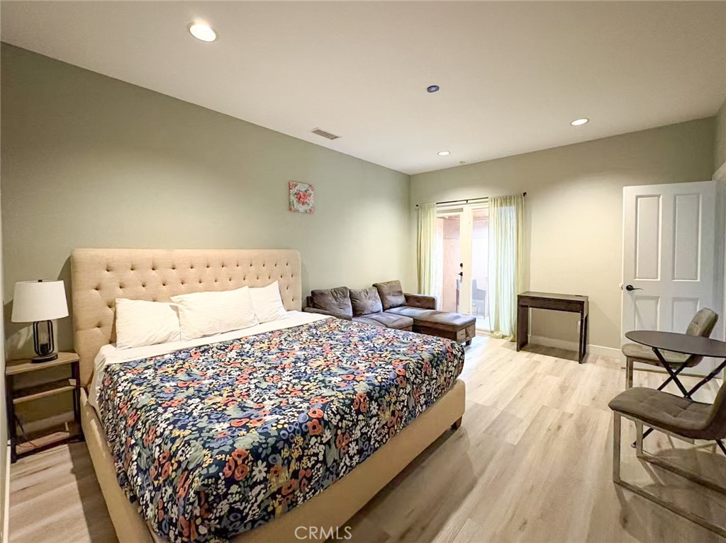 45700 Adler Lane Temecula, CA 92590 - Photo 10 of 20 a bedroom with a large bed a rug and chair