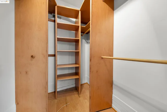 a view of walk in closet with empty racks