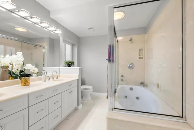 a bathroom with a double vanity sink mirror double and bathtub