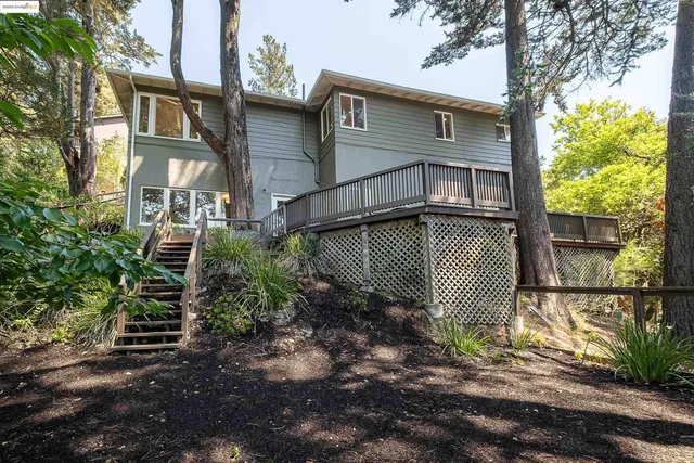 a front view of a house with a yard and seating area