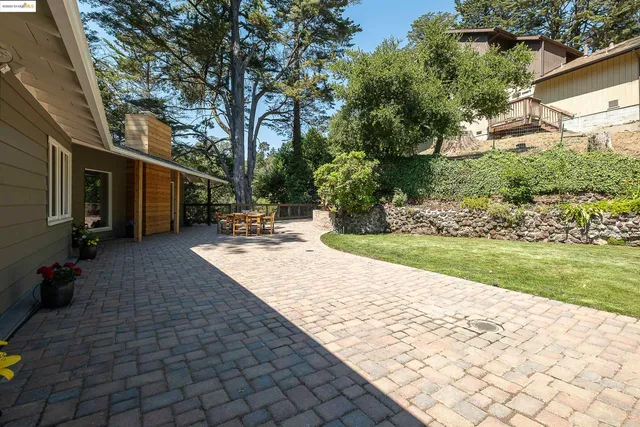 a view of a backyard with sitting area