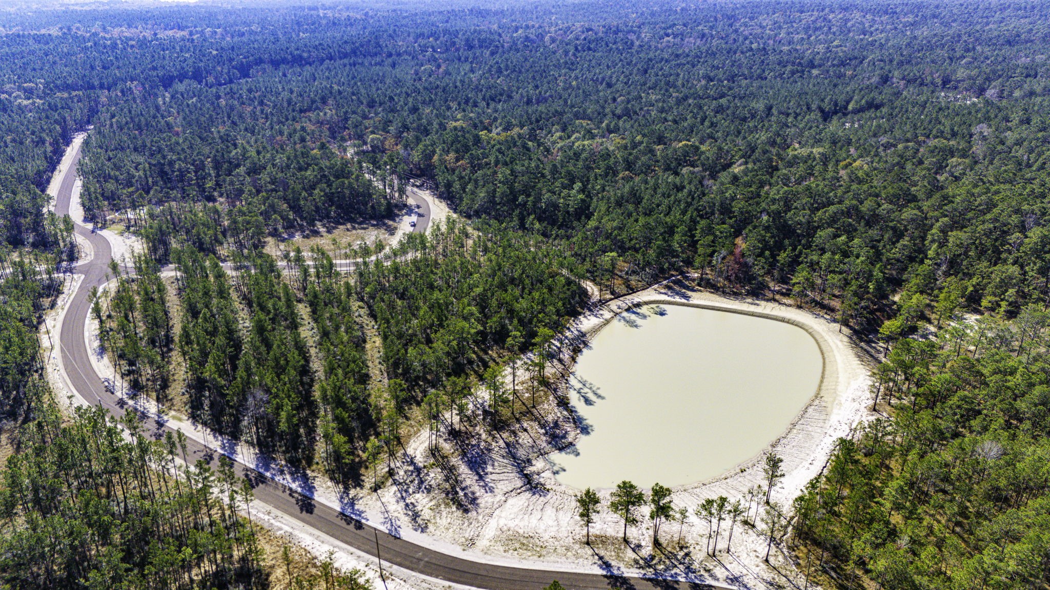 25 Magnolia Ranch Road Onalaska, TX 77360 - Photo 5 of 18 a view of a swimming pool with a yard and trees
