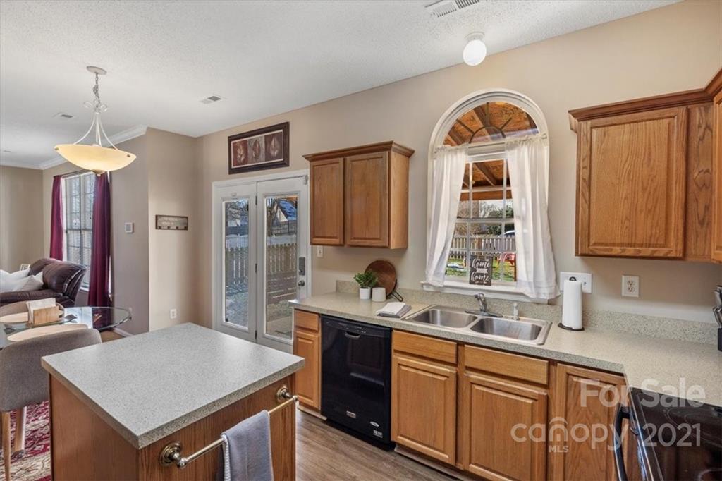 3919 Faith Church Road Indian Trail, NC 28079 - Photo 13 of 34 a kitchen with a sink stove and cabinets