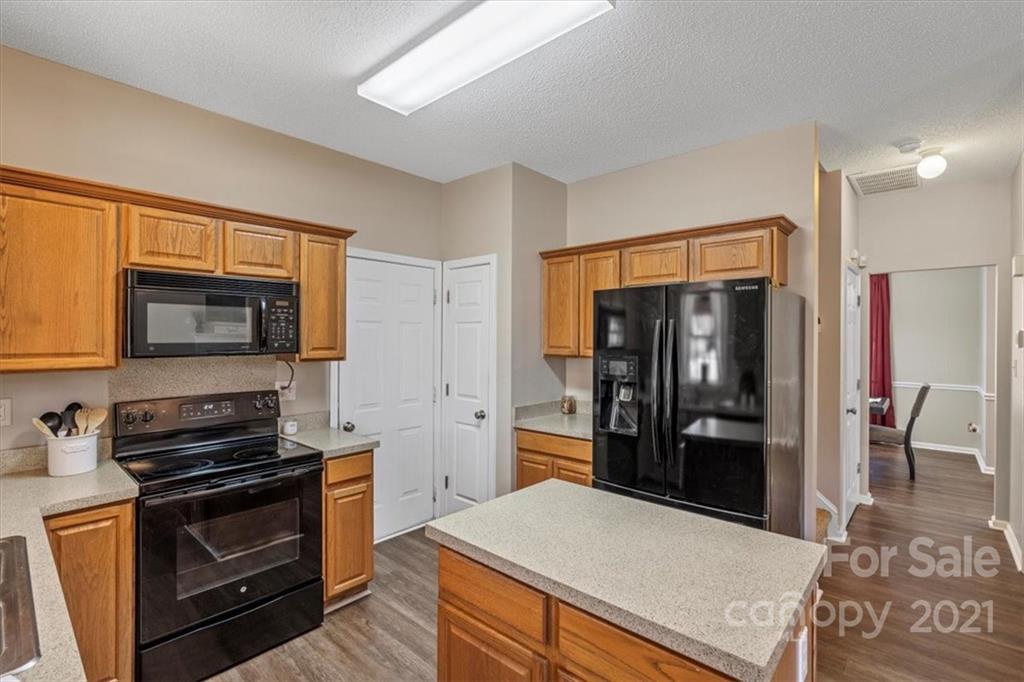 3919 Faith Church Road Indian Trail, NC 28079 - Photo 14 of 34 a kitchen with granite countertop a refrigerator stove and oven