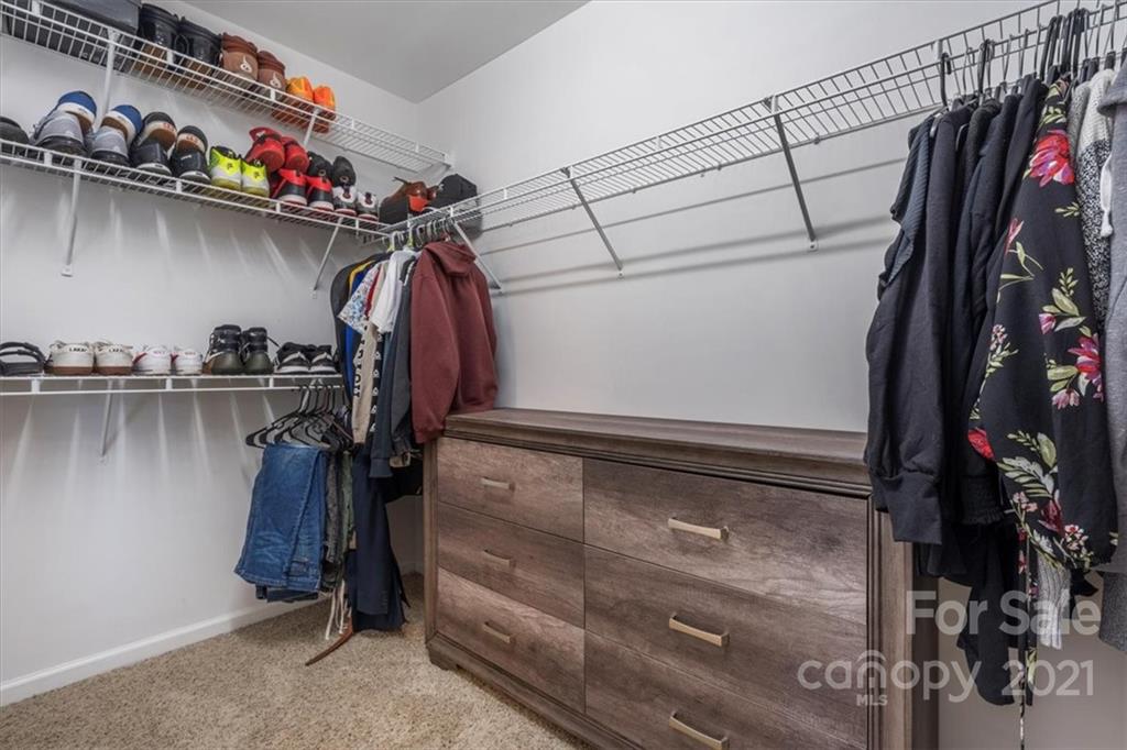 3919 Faith Church Road Indian Trail, NC 28079 - Photo 23 of 34 a view of walk in closet with clothes and shoes