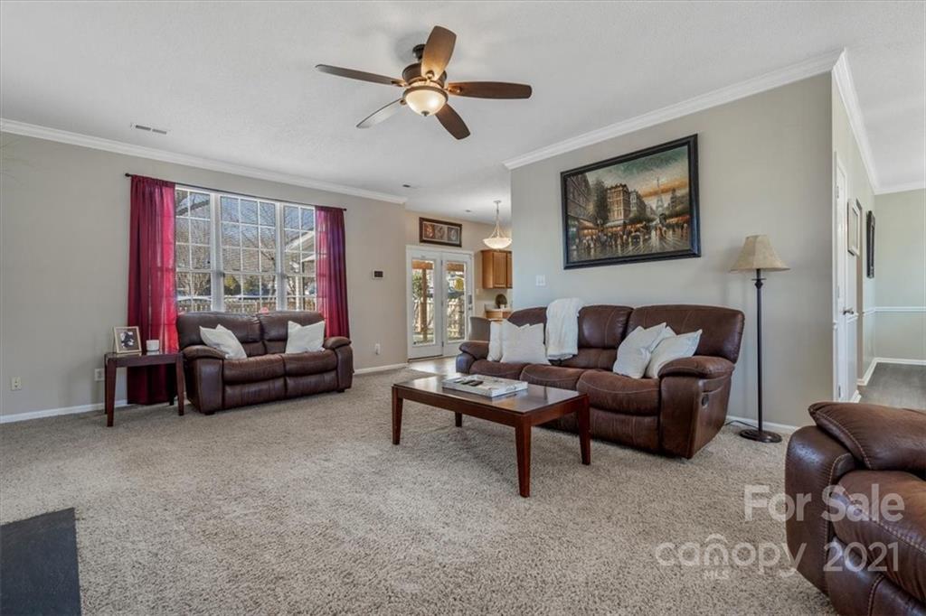 3919 Faith Church Road Indian Trail, NC 28079 - Photo 7 of 34 a living room with furniture and a ceiling fan