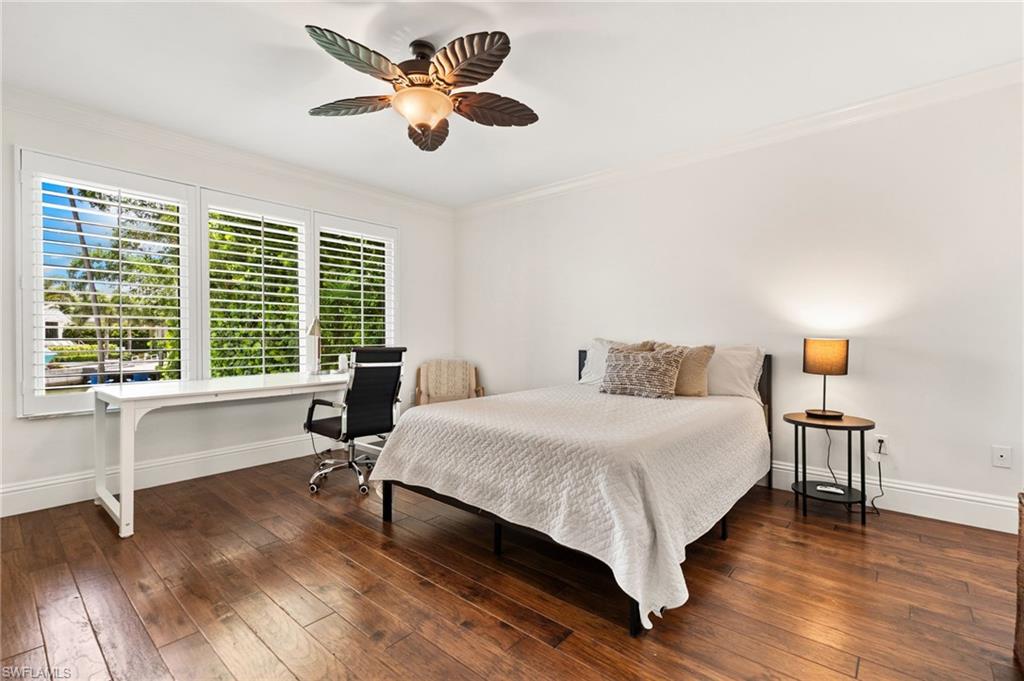 2201 Beacon Lane Naples, FL 34103 - Photo 17 of 25 a bedroom with a bed and a large window