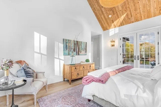 a bed room with a bed and a large window