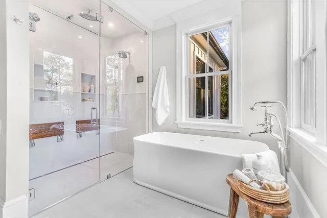 a view of a hallway with wooden floor and windows
