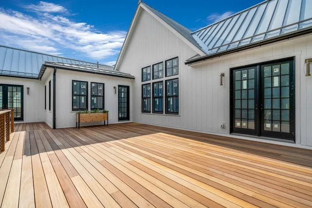 a view of a house with wooden floor and fence