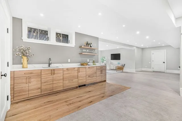 a living room with furniture a flat screen tv and a large window