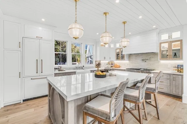 a dining room with furniture a kitchen view and chandelier