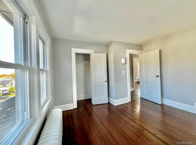 a big room with wooden floor and windows
