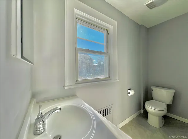 a white toilet sitting next to a bathroom sink