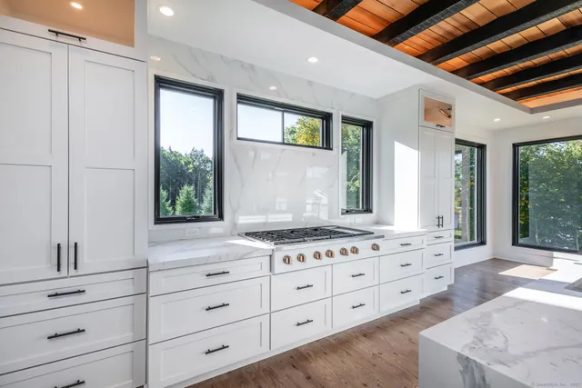 an empty room with wooden floor and a fireplace