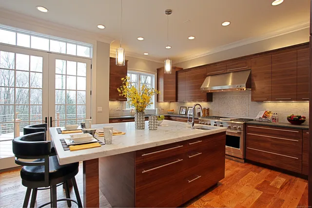 a kitchen with stainless steel appliances granite countertop a sink and a stove top oven